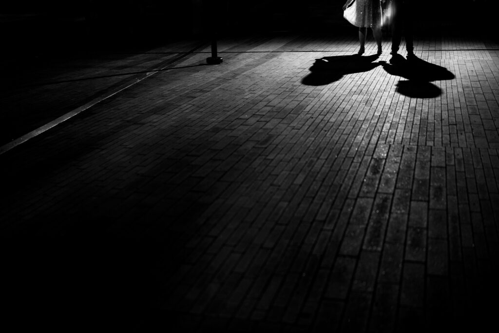 shadows on the ground of a couple standing together