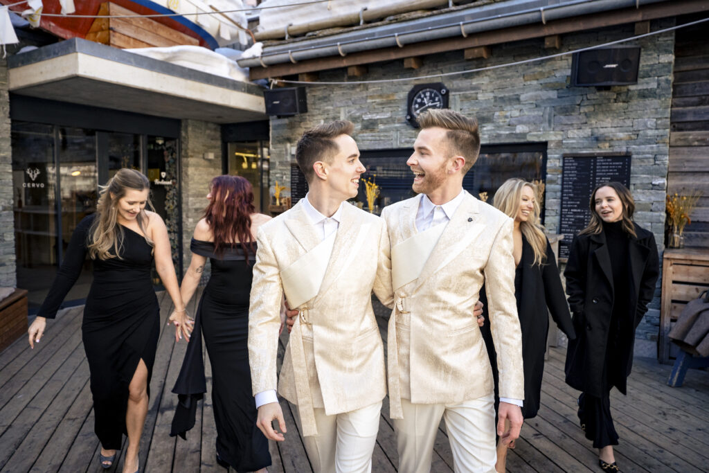 Matt and Brady surrounded by friends at their Swiss Alps wedding reception at Cervo Resort in Zermatt, Switzerland