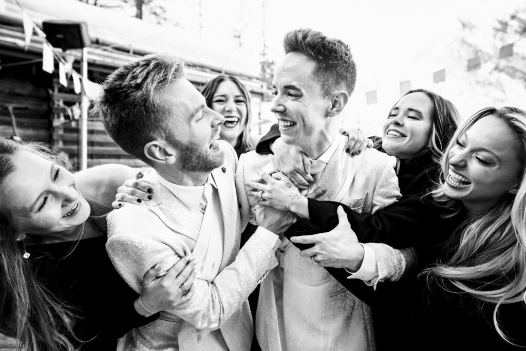 Matt and Brady surrounded by friends at their Swiss Alps wedding reception at Cervo Resort in Zermatt, Switzerland
