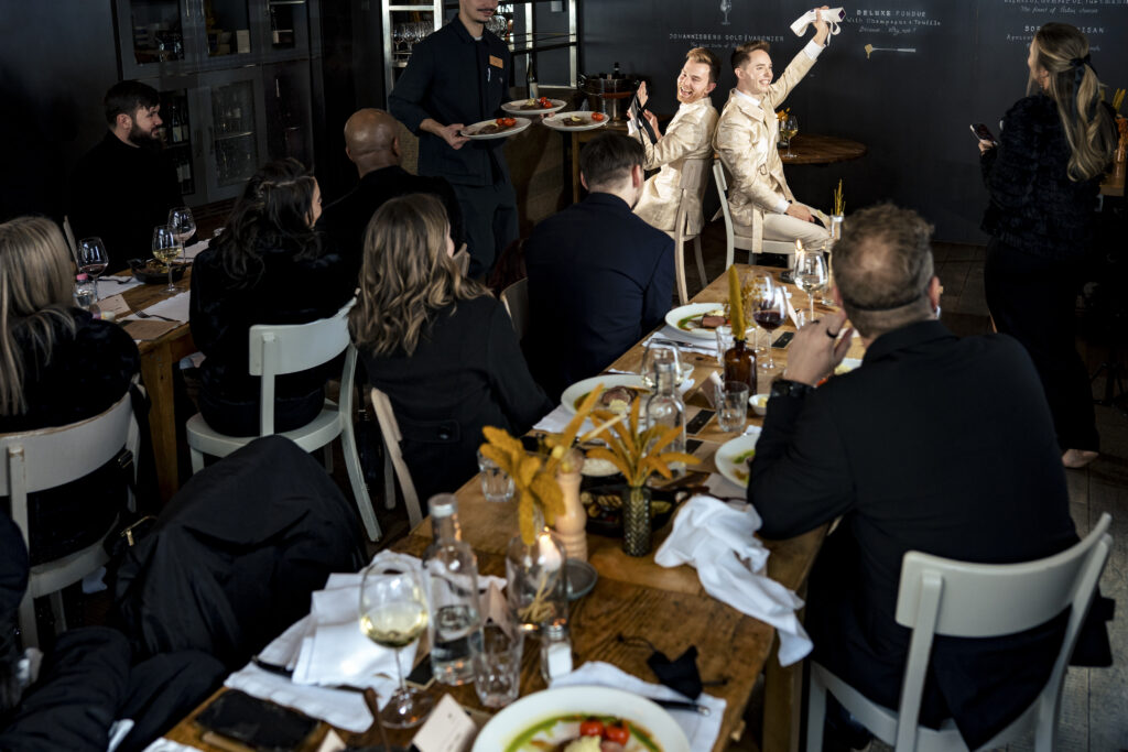 Matt and Brady's wedding guests raising their glasses in a heartfelt toast at their Swiss Alps wedding reception at Cervo Resort in Zermatt, Switzerland