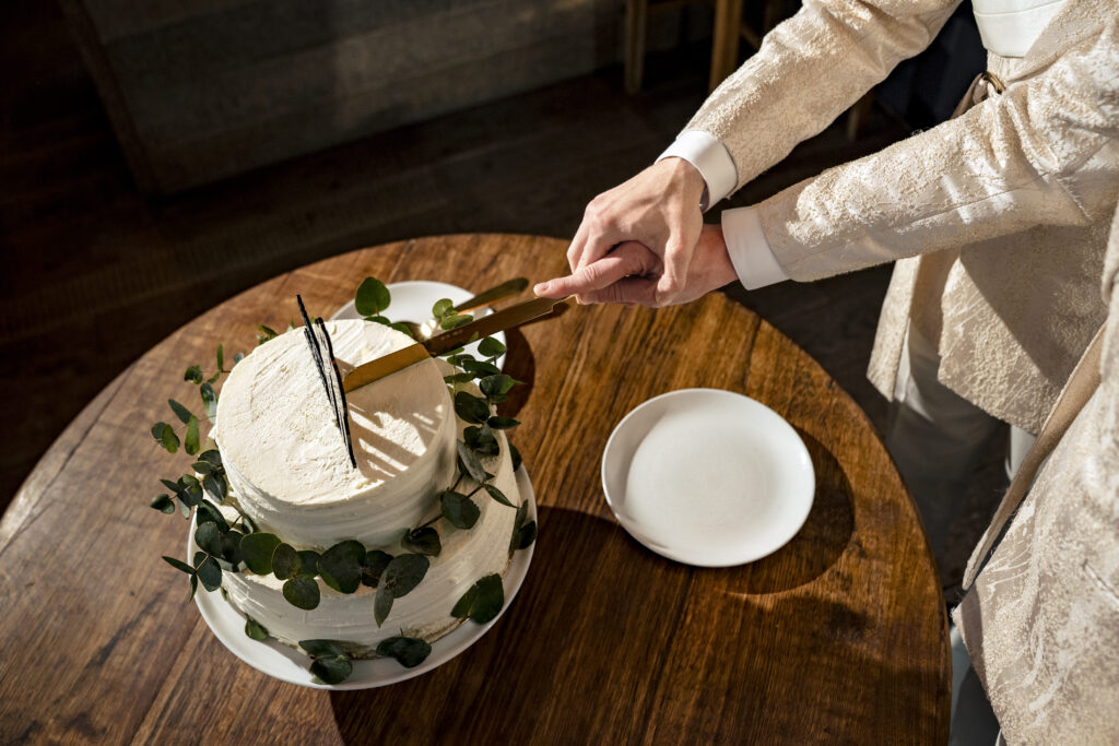 Matt and Brady cutting the cake at their Swiss Alps wedding reception at Cervo Resort in Zermatt, Switzerland