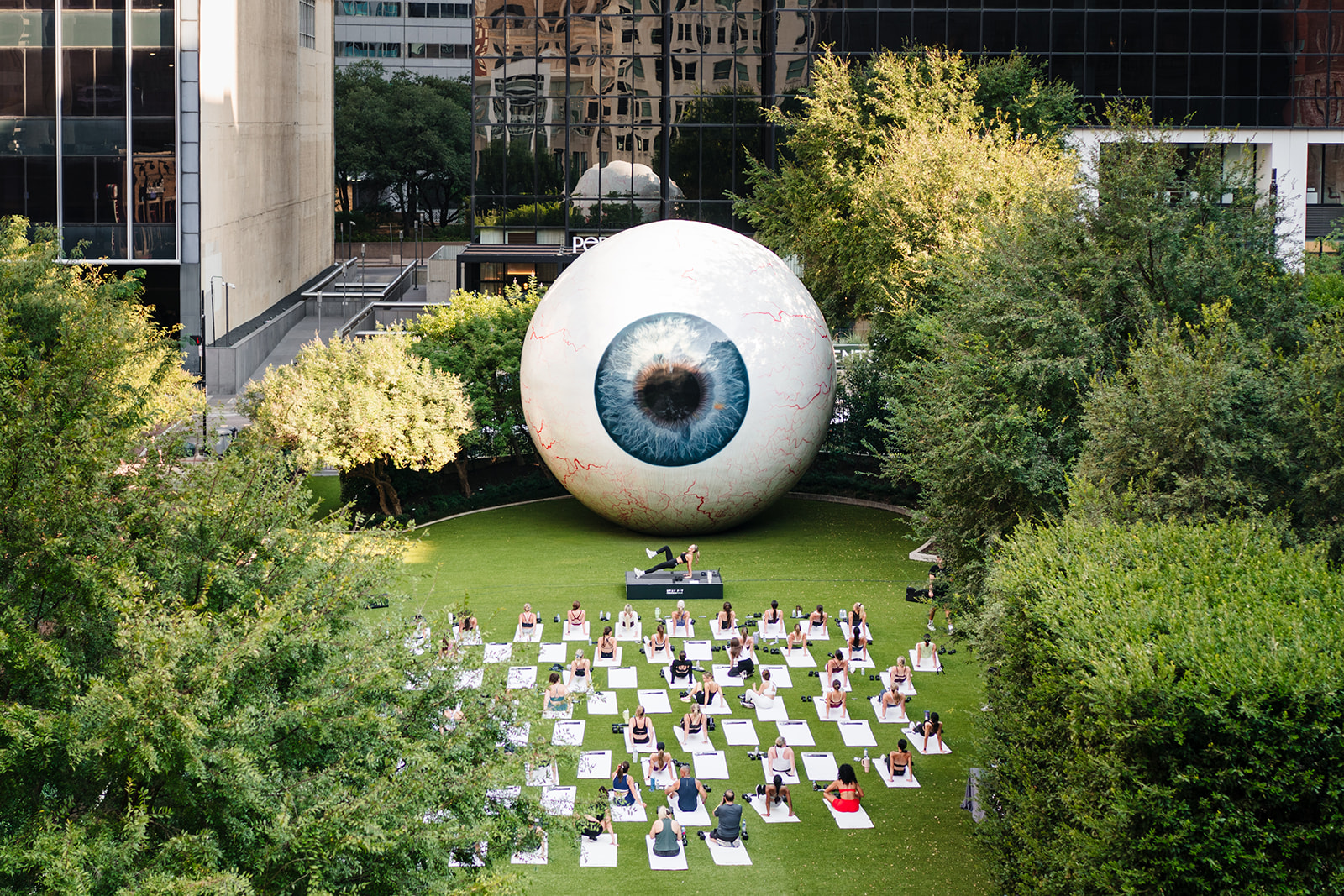View from The Joule rooftop terrace of a sunrise fitness class at The Eye