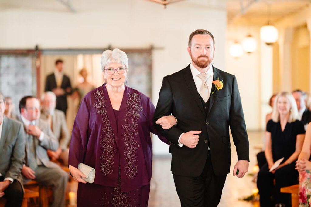 Groom entering wedding ceremony at Brik Venue in Fort Worth by DFW Wedding Photographers The MacMeekens