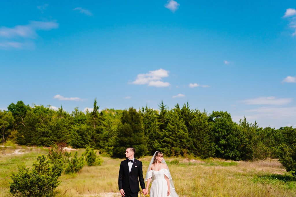 Bride and groom portrait through green leaves, soft natural light