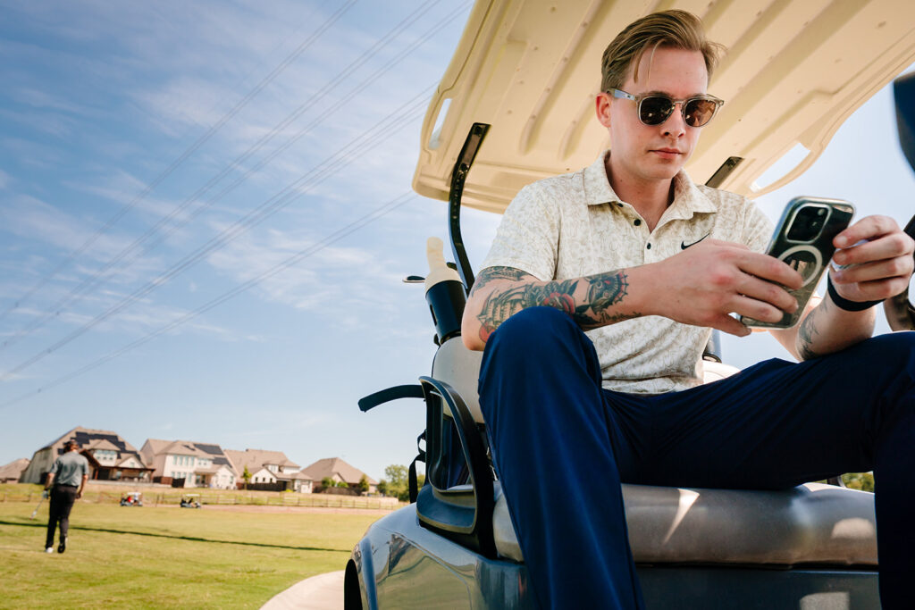 Groom sitting on golf cart 