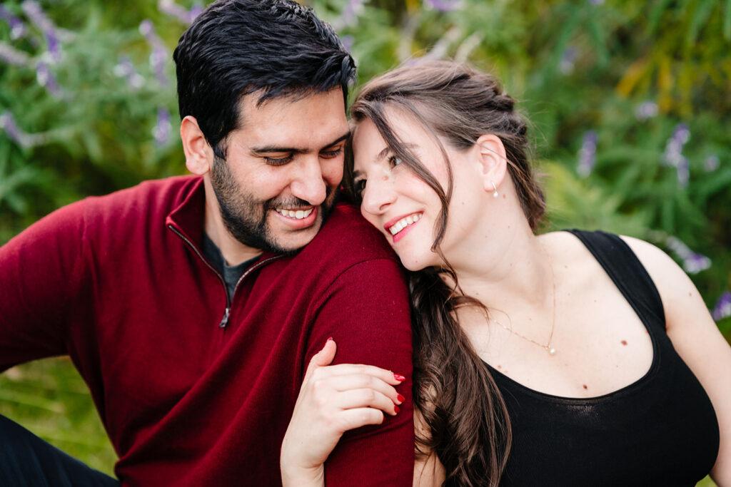 Romantic photo of couple sitting together in the grass at the Meyerson in Downtown Dallas.