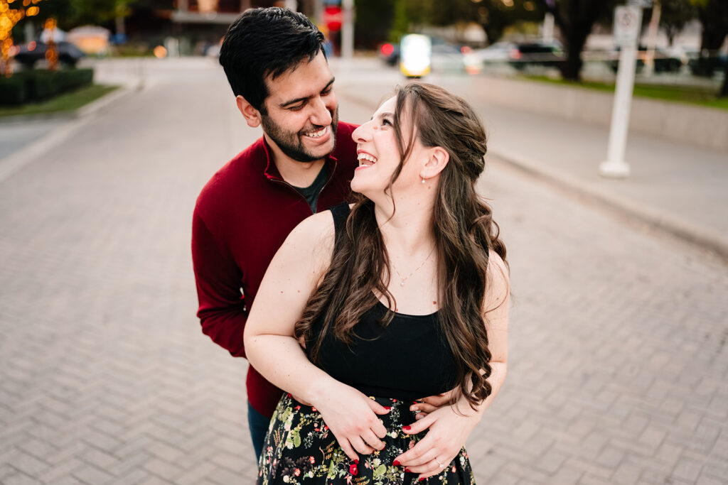 Couple embracing while laughing together out front of the meyerson symphony center in downtown dallas