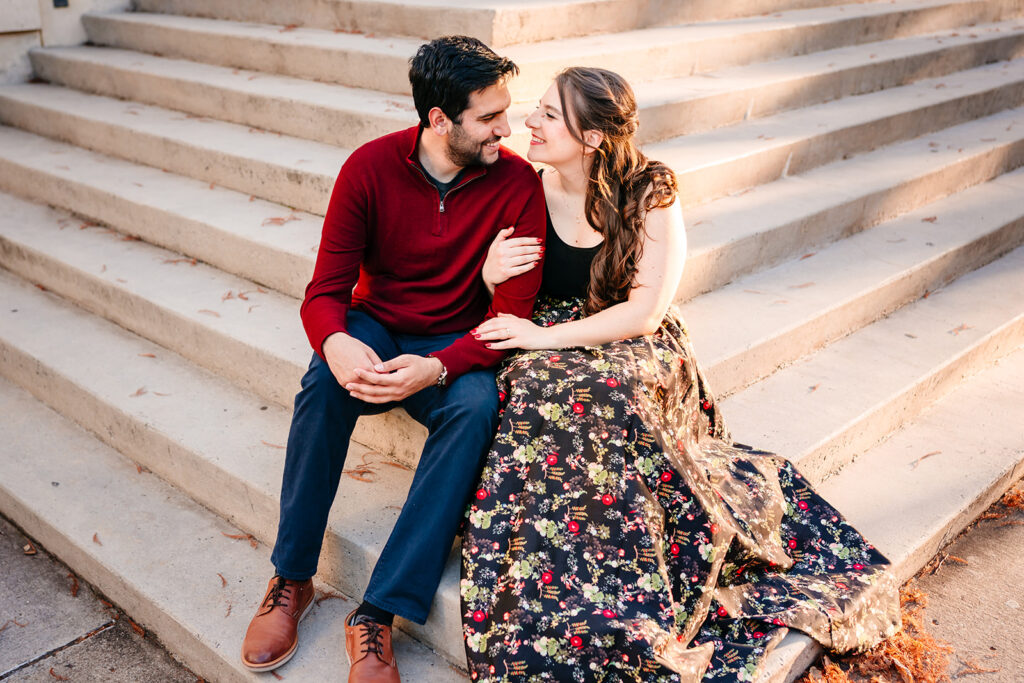 couple embracing while sitting on the steps out front of the meyerson symphony center