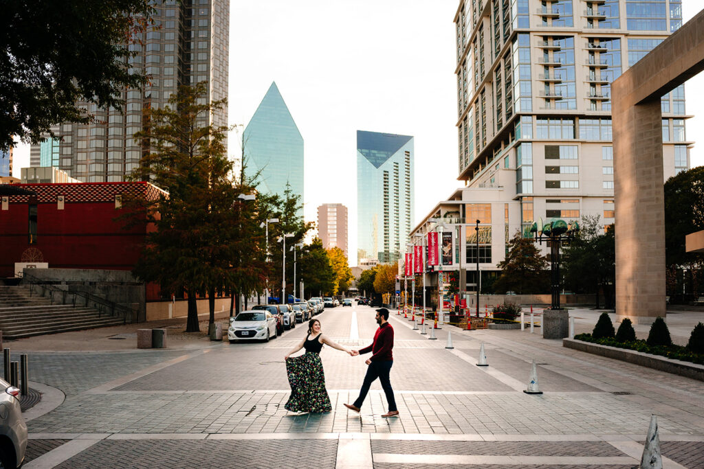 couple walking across the road together in downtown dallas