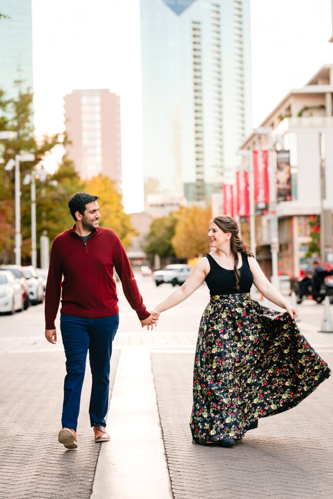 couple walking across the road together in downtown dallas