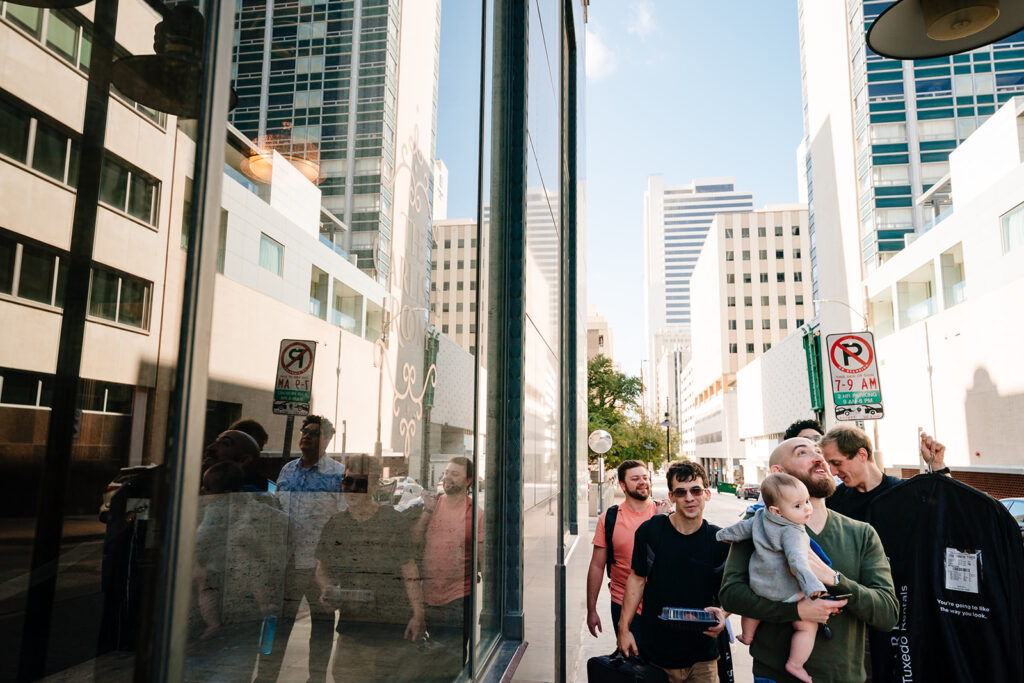Candid groom getting ready moments before Dallas wedding ceremony at Tyler Street Church