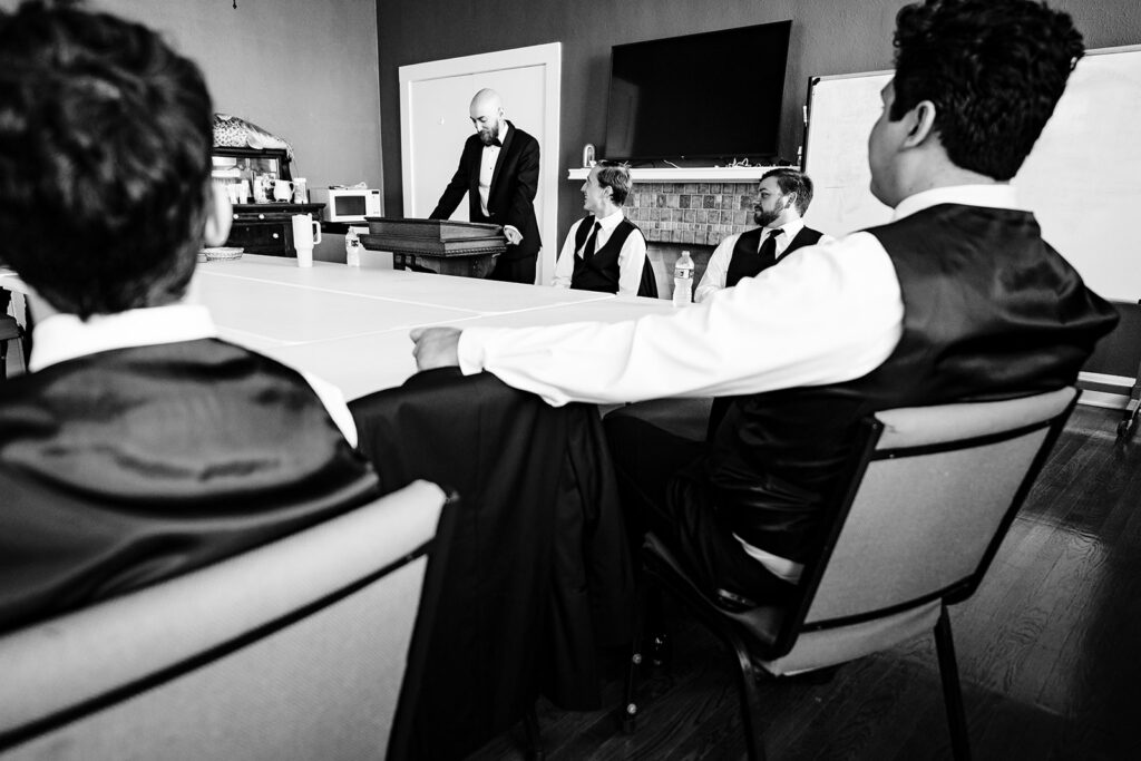Candid groom getting ready at The Carlisle Room moments before Dallas wedding ceremony at Tyler Street Church