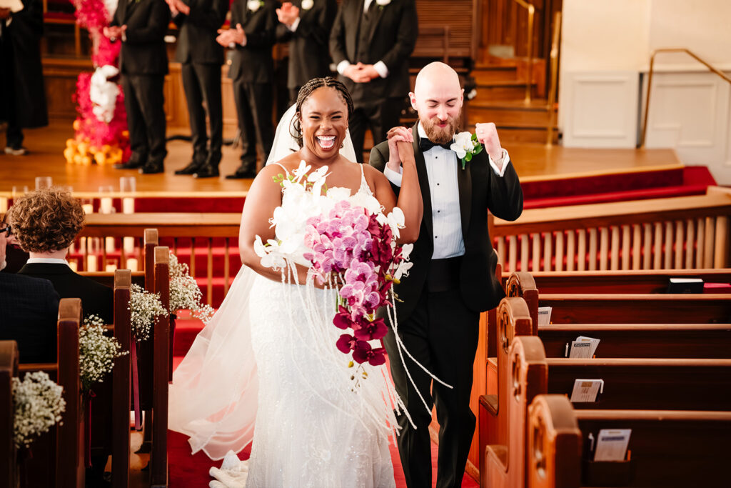 Bride and groom leaving their multicultural wedding ceremony at Tyler Street Church Dallas