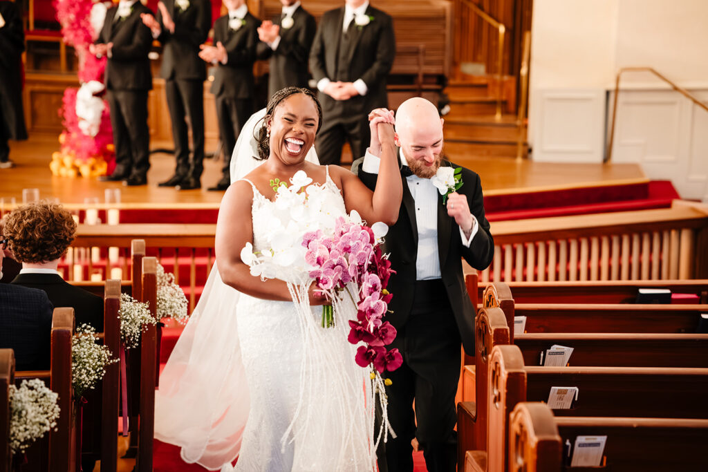 Bride and groom leaving their multicultural wedding ceremony at Tyler Street Church Dallas