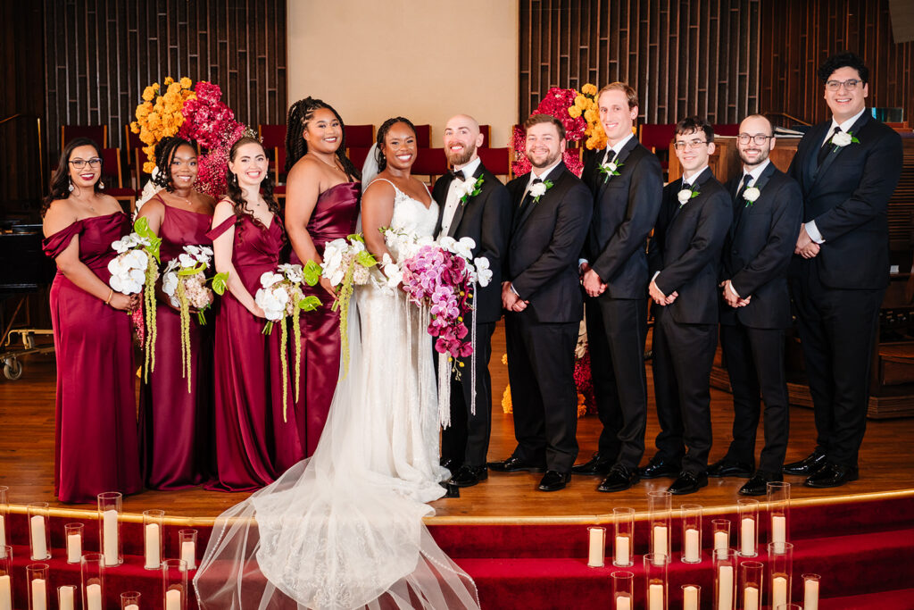 Bride and groom stand with their wedding party for formal photo after weddi
