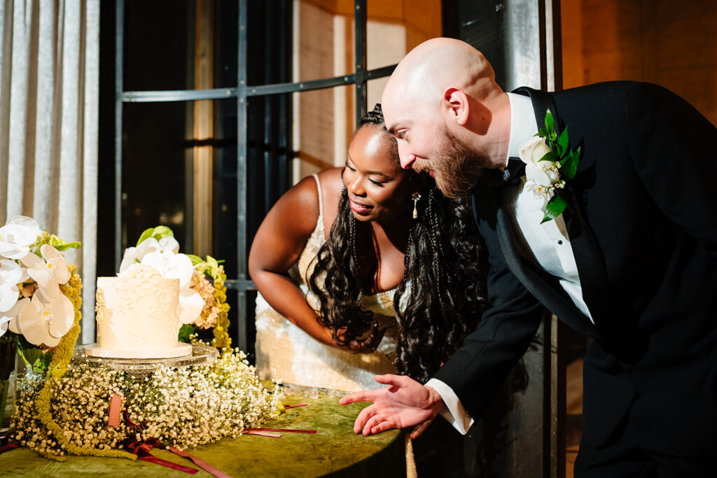 Bride and groom seeing their wedding cake for the first time at The Carlisle Room