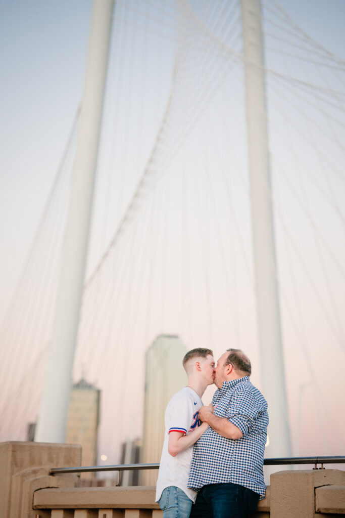 Queer Dallas Engagement Session with Cinematic Skyline Views at Margaret Hunt Hill Bridge