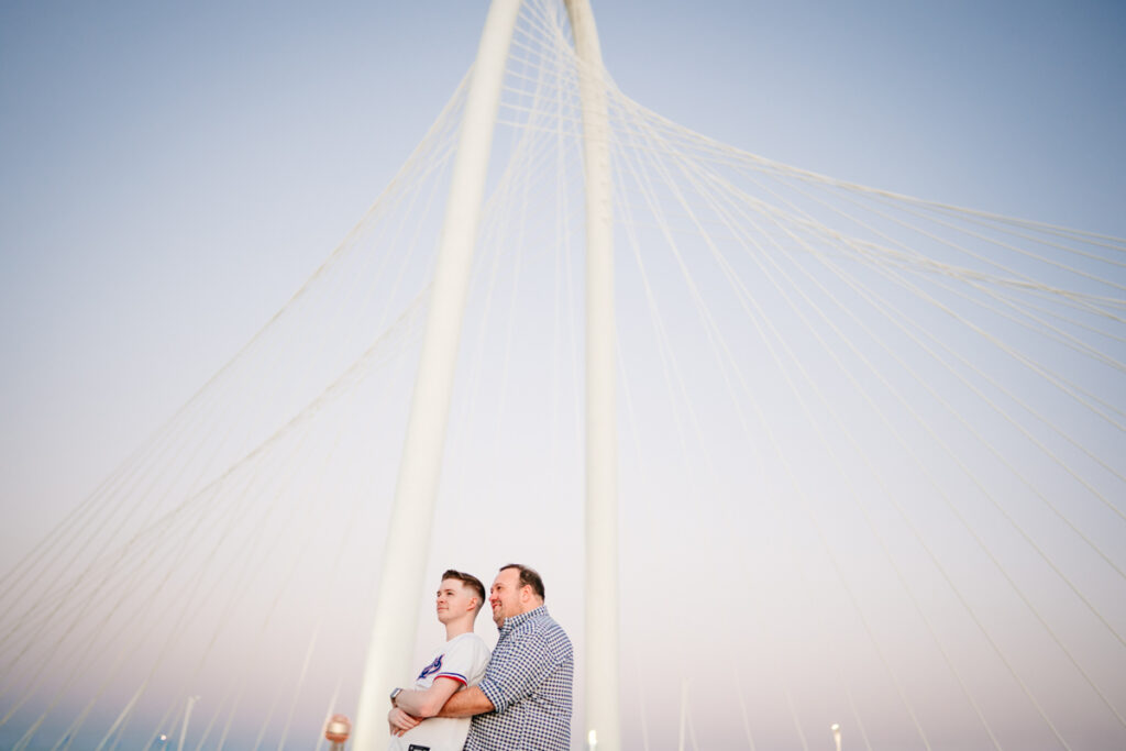 Queer Dallas Engagement Session with Cinematic Skyline Views at Margaret Hunt Hill Bridge