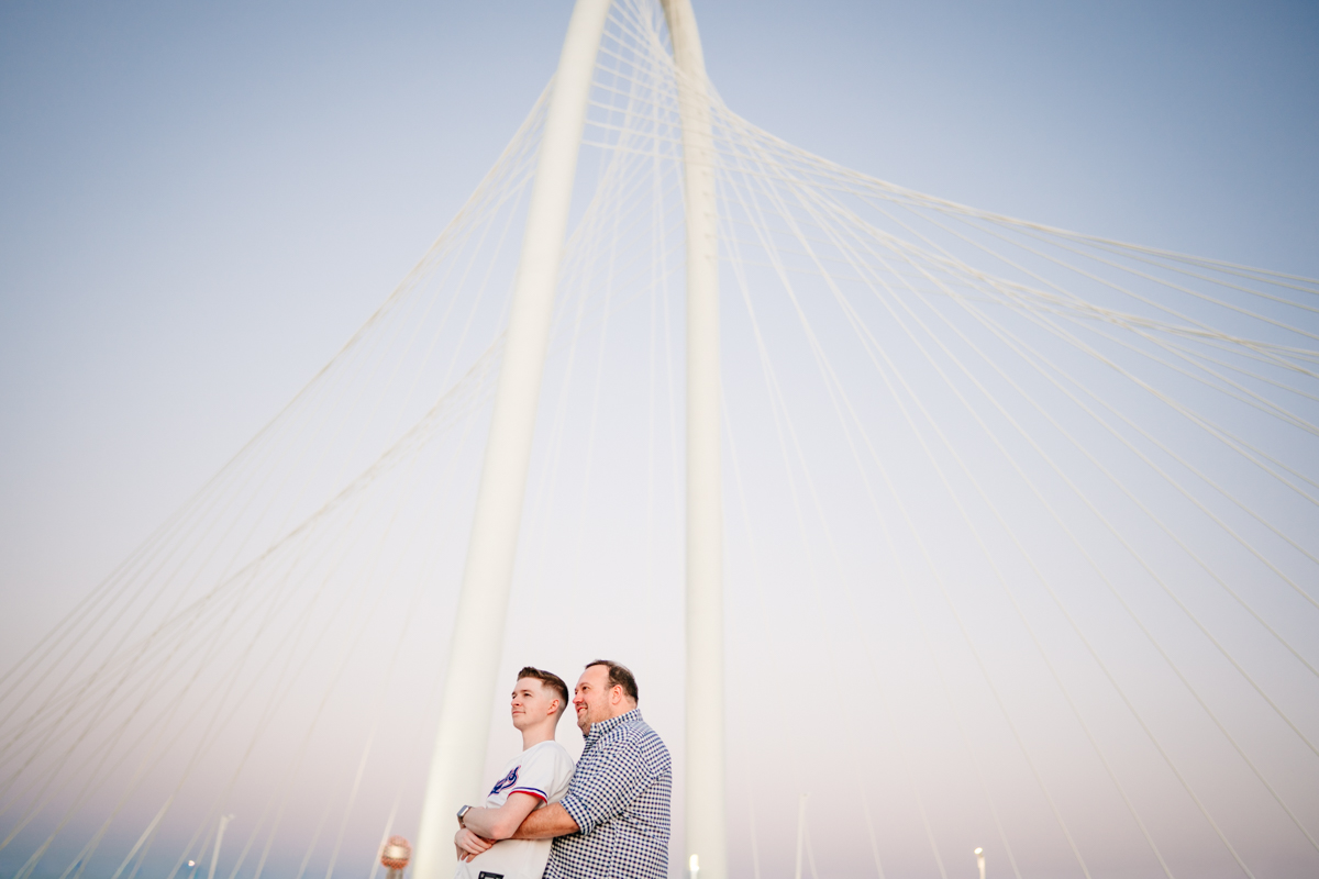 Queer Dallas Engagement Session with Cinematic Skyline Views at Margaret Hunt Hill Bridge