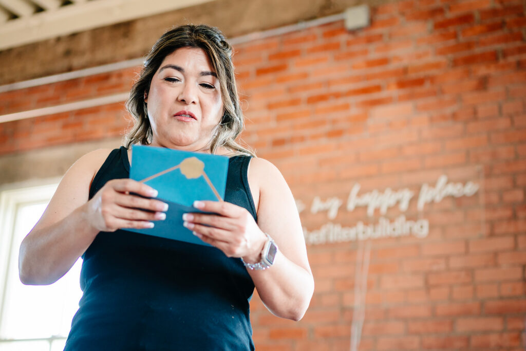 Bride getting ready for North Texas LGBTQ Wedding at The Filter Building on White Rock Lake by Dallas Inclusive Wedding Photographers