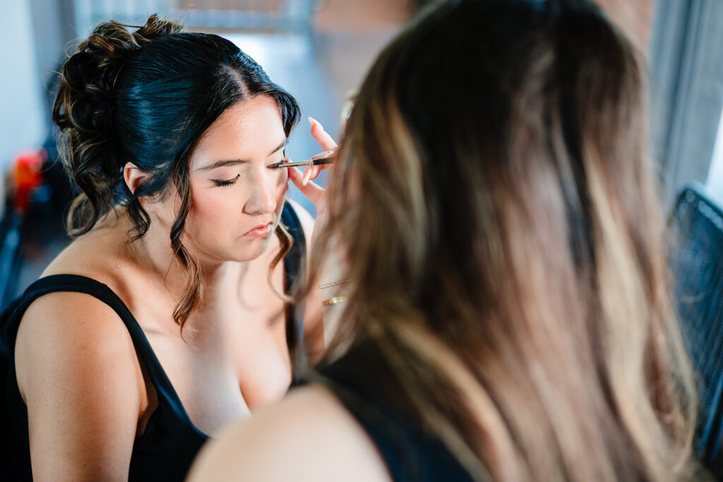 Bride getting ready for North Texas LGBTQ Wedding at The Filter Building on White Rock Lake by Dallas Inclusive Wedding Photographers