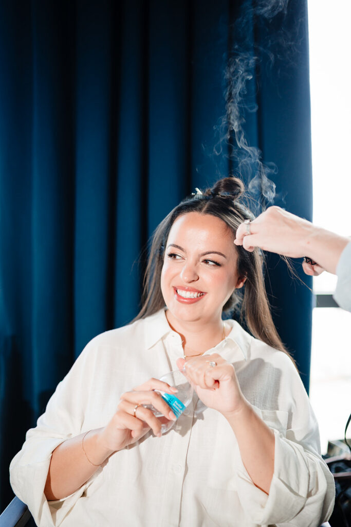 Bride getting ready for North Texas LGBTQ Wedding at The Filter Building on White Rock Lake by Dallas Inclusive Wedding Photographers