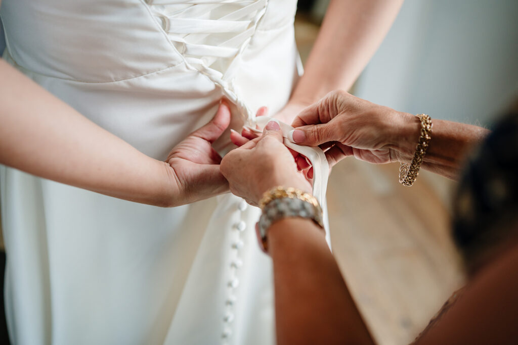 Bride getting ready for North Texas LGBTQ Wedding at The Filter Building on White Rock Lake by Dallas Inclusive Wedding Photographers
