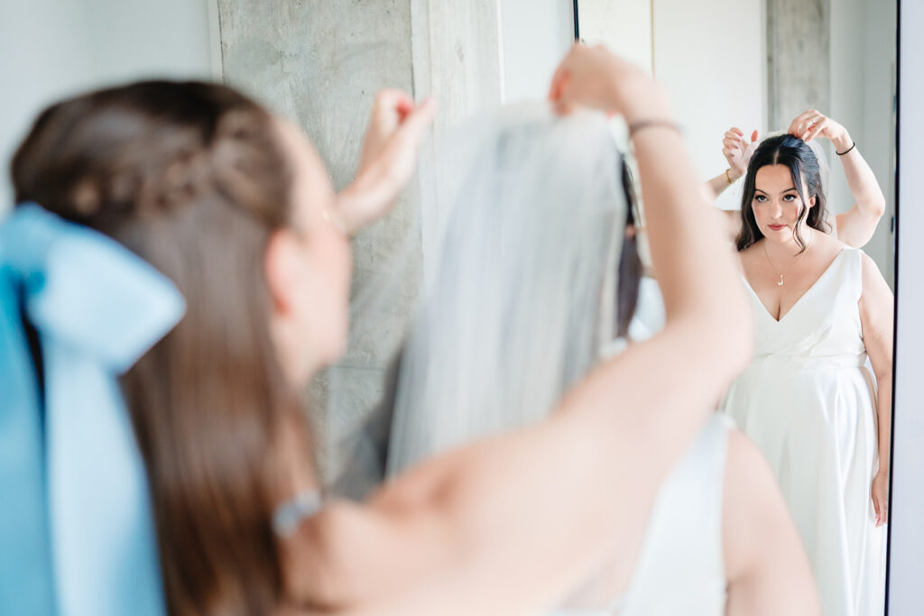 Bride getting ready for North Texas LGBTQ Wedding at The Filter Building on White Rock Lake by Dallas Inclusive Wedding Photographers