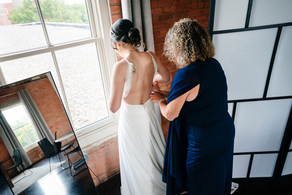 Bride getting ready for North Texas LGBTQ Wedding at The Filter Building on White Rock Lake by Dallas Inclusive Wedding Photographers
