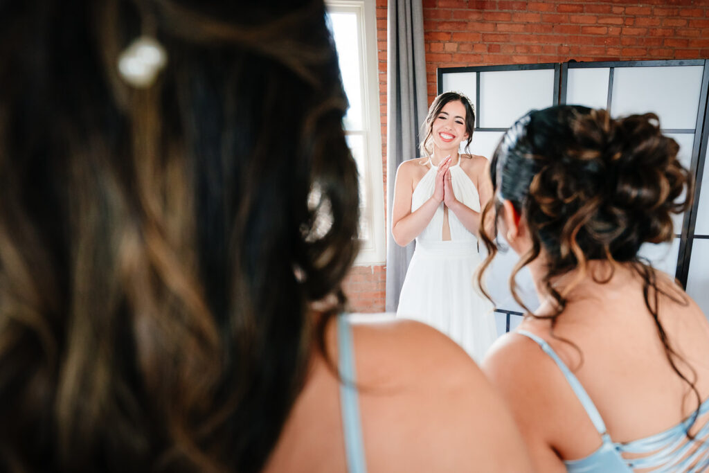Bride getting ready for North Texas LGBTQ Wedding at The Filter Building on White Rock Lake by Dallas Inclusive Wedding Photographers