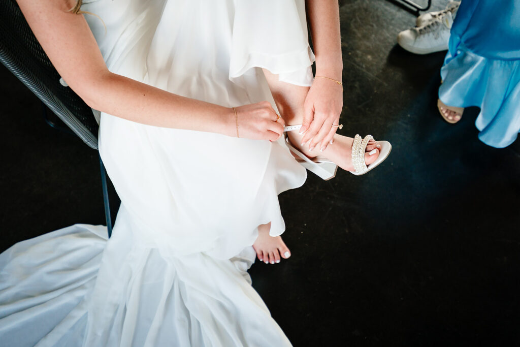 Bride getting ready for North Texas LGBTQ Wedding at The Filter Building on White Rock Lake by Dallas Inclusive Wedding Photographers