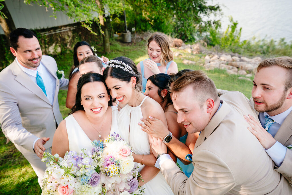Brides with their wedding party During North Texas LGBTQ Wedding Portraits at The Filter Building on White Rock Lake by Dallas Inclusive Wedding Photographers