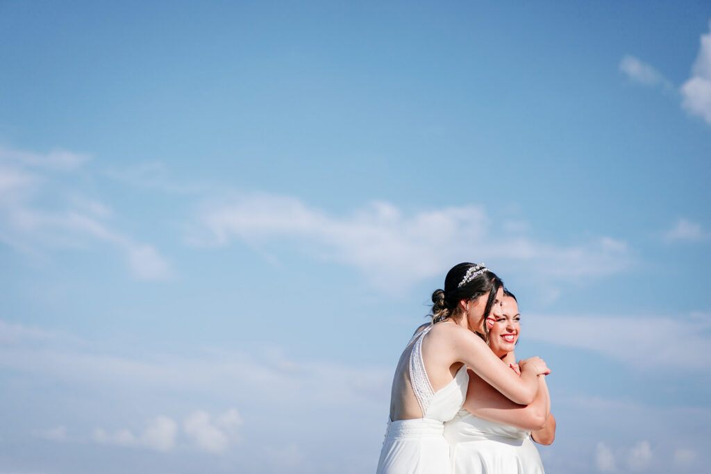 Couples Portraits of Lesbian Brides During North Texas LGBTQ Wedding at The Filter Building on White Rock Lake by Dallas Inclusive Wedding Photographers