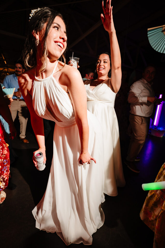 Lesbian Brides Dancing During their North Texas LGBTQ Wedding Reception at The Filter Building on White Rock Lake by Dallas Inclusive Wedding Photographers