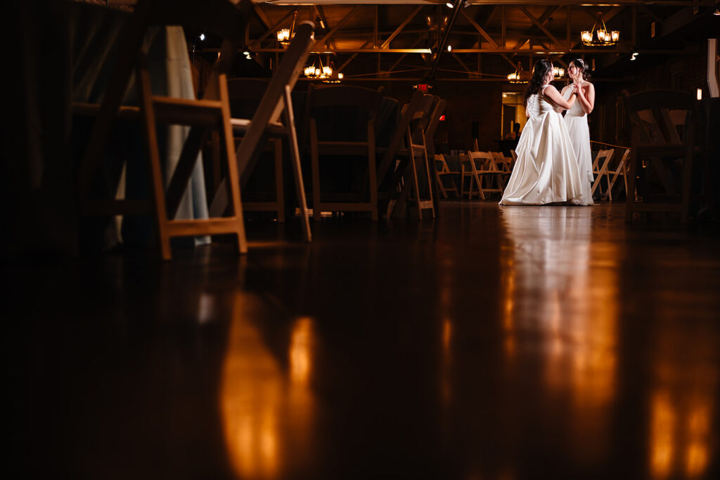 Lesbian Brides Dancing their Private Last Dance during their LGBTQ Wedding at The Filter Building on White Rock Lake by Dallas Inclusive Wedding Photographers